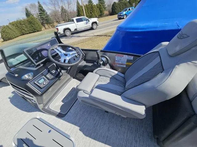 Slide: The Image of Interior of 2025 Bennington M Quad Bench 22 MFB boat with modern steering and seating. - 6