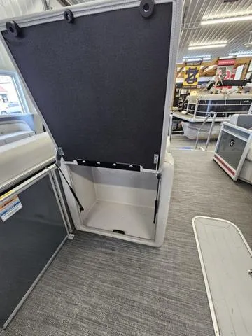 Slide: The Image of Open storage compartment in 2025 Godfrey Sweetwater 2286 SFL pontoon boat interior. - 11