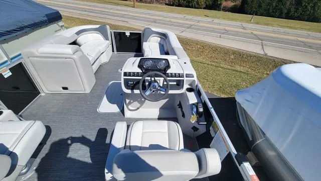 Slide: The Image of 2025 Godfrey Sweetwater 2286 SFL GTP pontoon boat interior with helm and seating. - 4