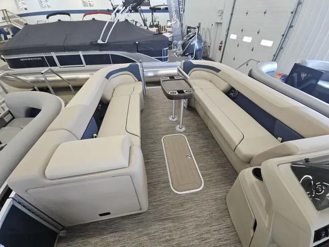 Slide: The Image of 2025 Godfrey Sweetwater 2486 SFL pontoon interior with beige seating and center table. - 10