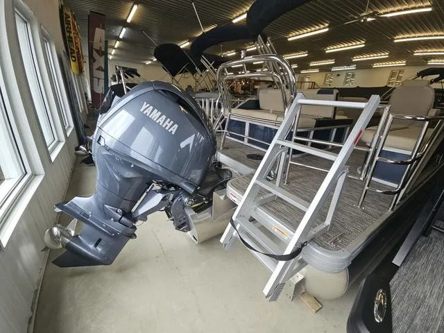 Slide: The Image of 2025 Godfrey Pontoons Sweetwater 2486 SFL with Yamaha motor, displayed indoors. - 12