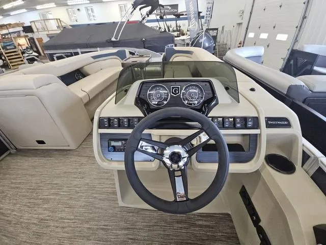 Slide: The Image of 2025 Godfrey Pontoons Sweetwater 2486 SFL GTP dashboard with steering wheel and controls. - 8