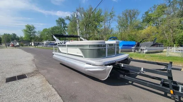 Slide: The Image of 2025 Godfrey Pontoons Xperience 1886 CX on trailer, parked on a sunny day. - 1