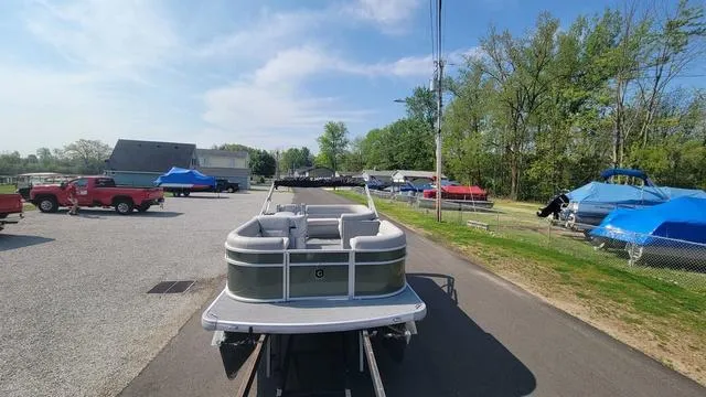 Slide: The Image of 2025 Godfrey Pontoons Xperience 1886 CX on trailer, parked outdoors under clear sky. - 12