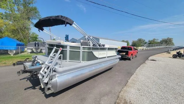 Slide: The Image of 2025 Godfrey Pontoons Xperience 1886 CX on trailer, parked outdoors under clear sky. - 2