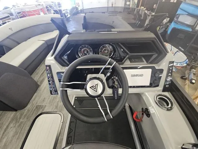 Slide: The Image of 2025 Viaggio LAGO Z 22S 3T boat dashboard with steering wheel and controls. - 3