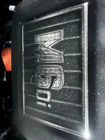 Slide: The Image of Close-up of 2025 Malibu 23 MXZ engine cover with "M6Di" logo. - 18