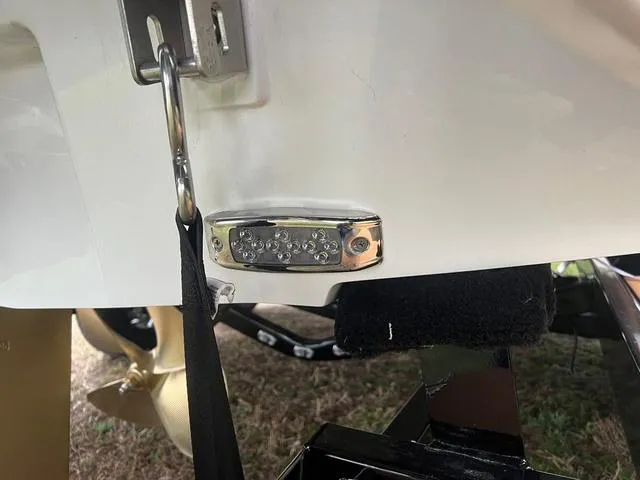 Slide: The Image of 2025 Malibu 23 MXZ boat detail with metal hardware and propeller. - 23