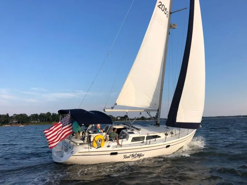 Slide: The Image of Sailing yacht Catalina 36, 2002 model, cruising on open water with American flag. - 0