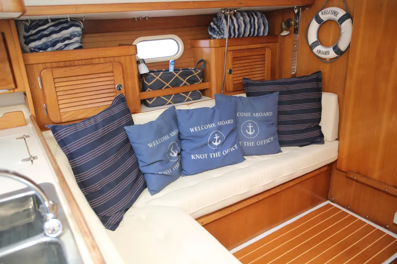 Slide: The Image of Cozy interior of 2002 Catalina 36 sailboat with nautical-themed cushions and wooden finish. - 10