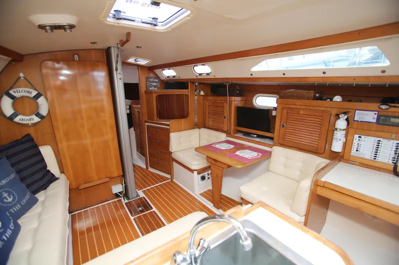 Slide: The Image of Interior of 2002 Catalina 36 sailboat with wood finish and cozy seating area. - 4