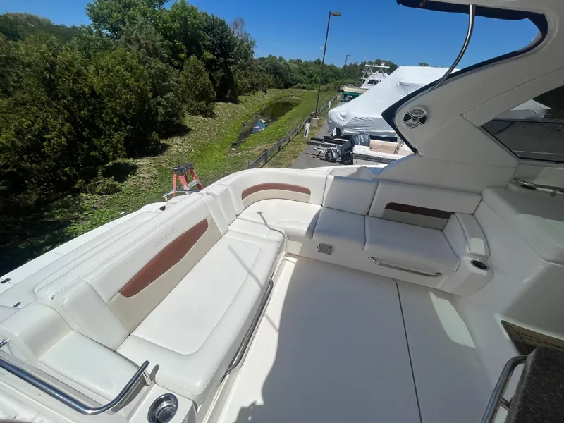 Slide: The Image of 2010 Chaparral 400 Premiere yacht with spacious white seating area, surrounded by greenery. - 11