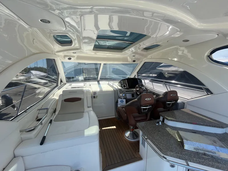 Slide: The Image of Interior of 2010 Chaparral 400 Premiere yacht with luxurious seating and modern helm. - 12