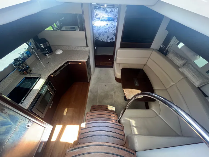 Slide: The Image of Interior of 2010 Chaparral 400 Premiere yacht with modern kitchen and cozy seating area. - 18