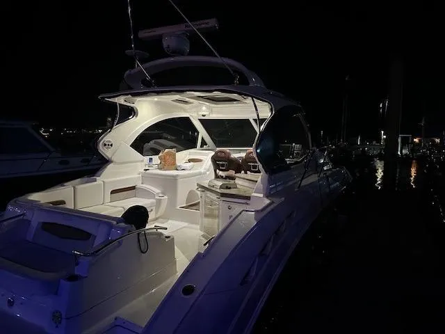 Slide: The Image of Chaparral 400 Premiere 2010 yacht illuminated at night in a marina setting. - 2