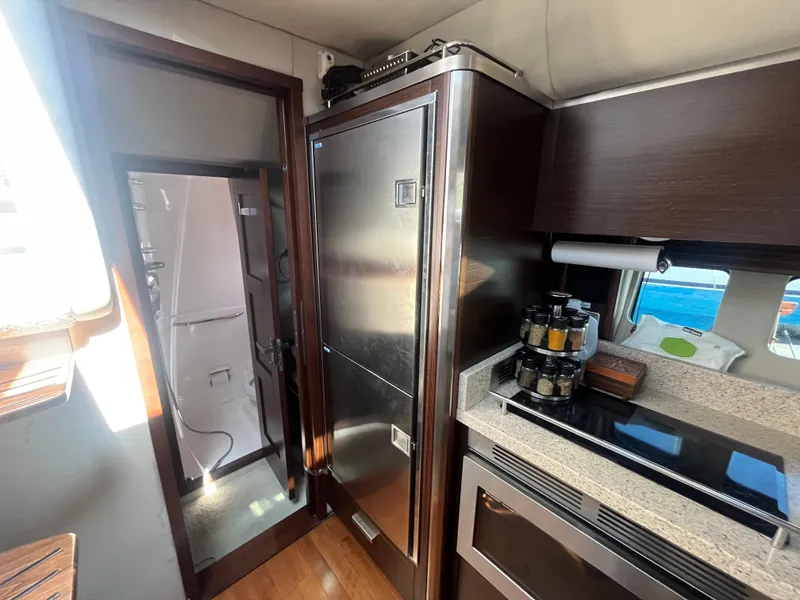 Slide: The Image of Interior of 2010 Chaparral 400 Premiere yacht kitchen with modern appliances and sleek design. - 21