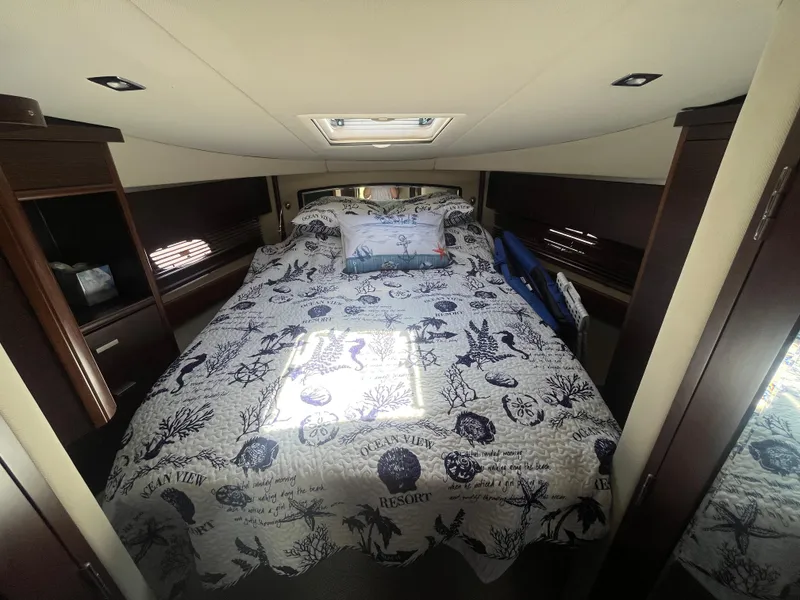 Slide: The Image of Luxurious bedroom interior of 2010 Chaparral 400 Premiere yacht with nautical-themed bedding. - 22
