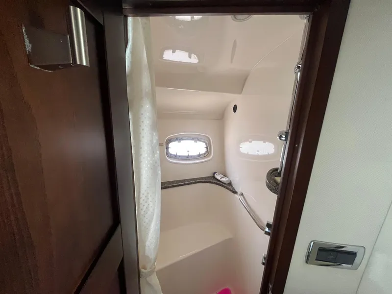 Slide: The Image of Interior view of 2010 Chaparral 400 Premiere yacht bathroom with shower and porthole. - 23