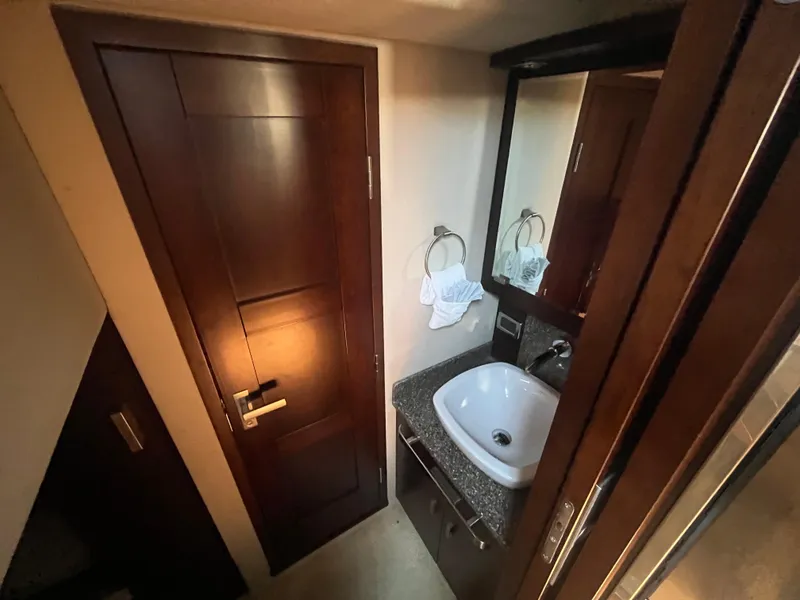 Slide: The Image of Chaparral 400 Premiere 2010 yacht bathroom with wooden door, sink, and mirror. - 26
