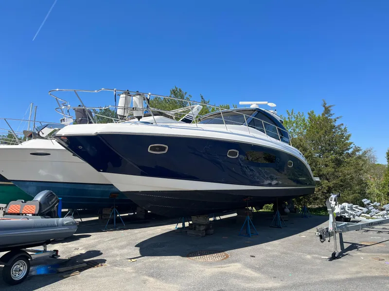 Slide: The Image of Chaparral 400 Premiere 2010 yacht on stands, blue hull, clear sky background. - 4