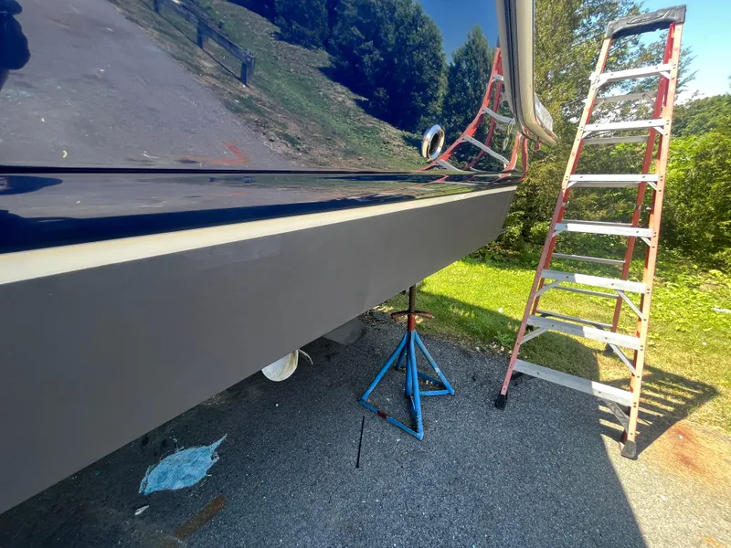 Slide: The Image of Chaparral 400 Premiere 2010 boat hull with ladder and support stand on pavement. - 6