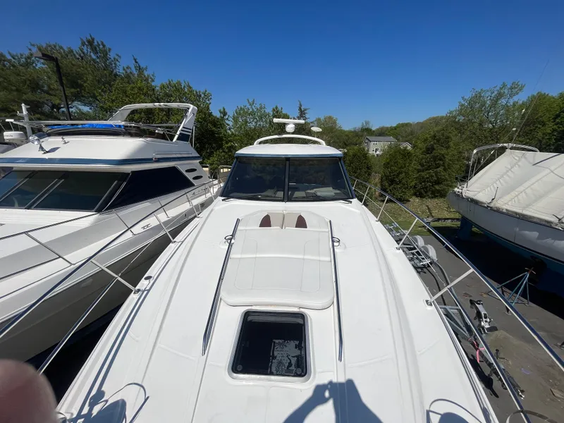 Slide: The Image of 2010 Chaparral 400 Premiere yacht docked, surrounded by trees and other boats. - 9
