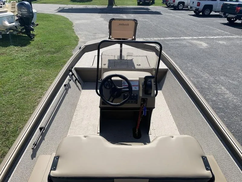 Slide: The Image of 2025 SeaArk Shadow 18 Center Console boat with steering wheel and control panel. - 10