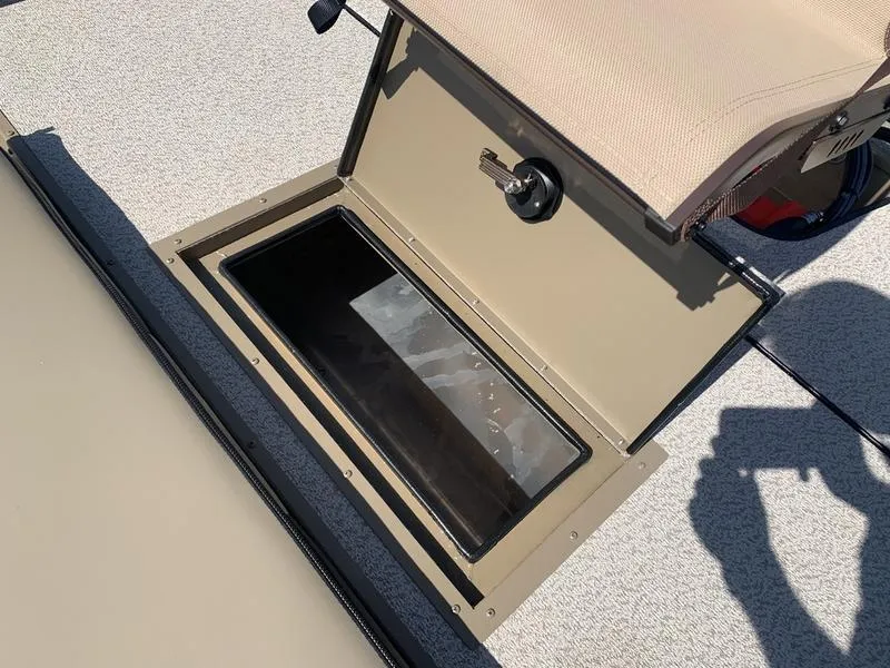 Slide: The Image of 2025 SeaArk Shadow 18 Center Console storage compartment open on deck. - 12