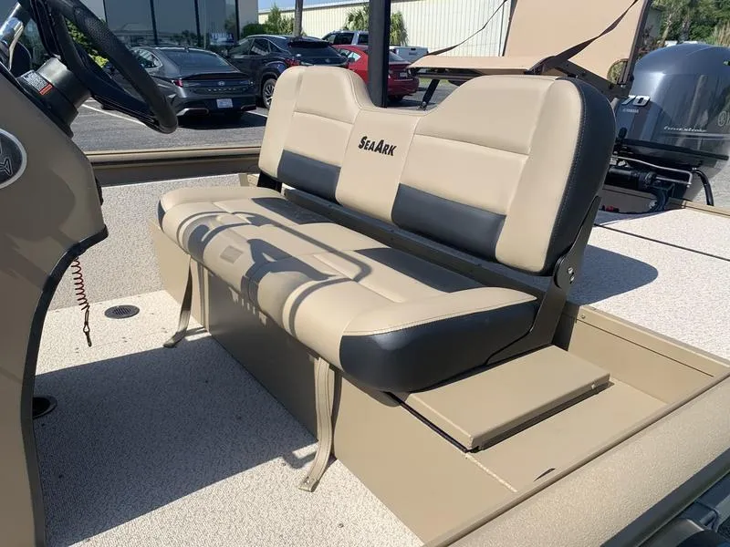 Slide: The Image of 2025 SeaArk Shadow 18 Center Console boat with beige seating and console. - 13