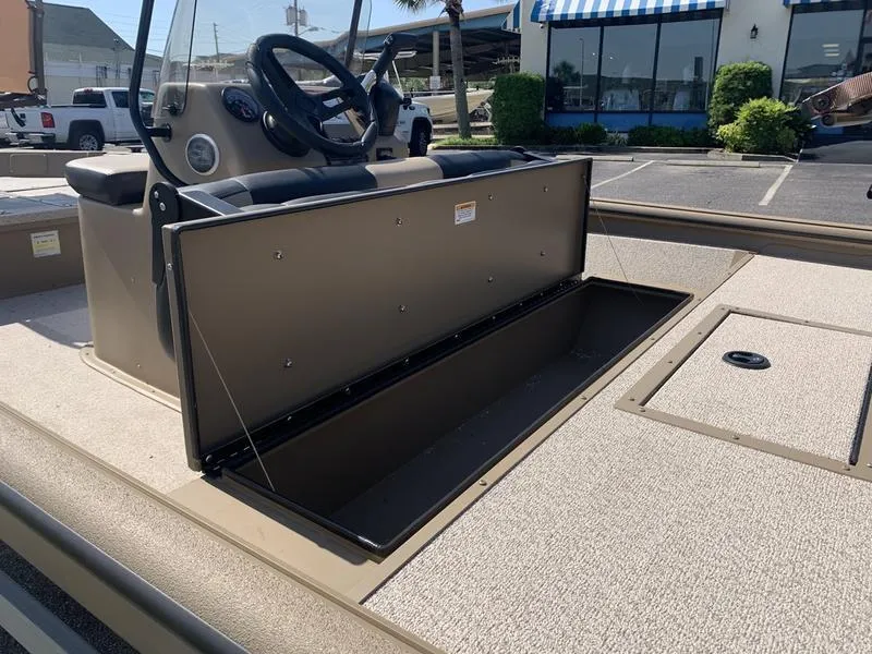 Slide: The Image of 2025 SeaArk Shadow 18 Center Console boat with open storage compartment. - 14
