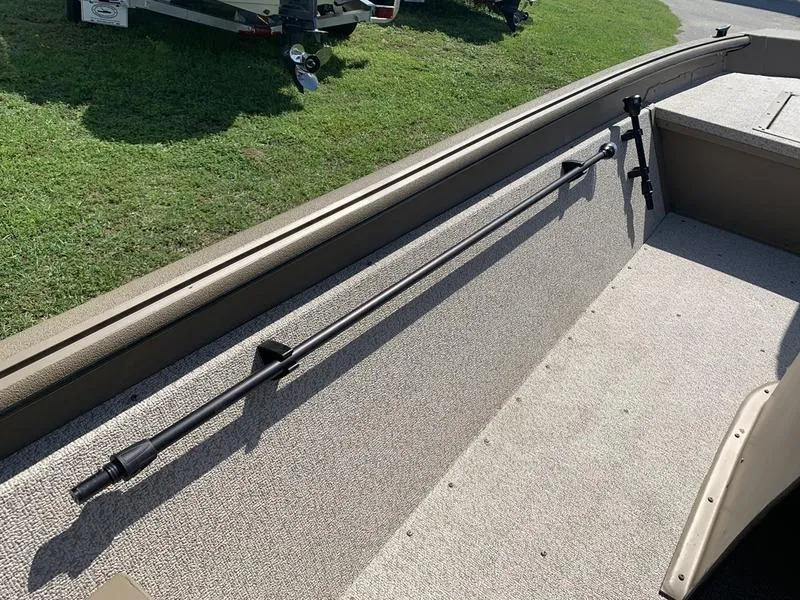 Slide: The Image of 2025 SeaArk Shadow 18 Center Console interior with rod holders and carpeted flooring. - 16