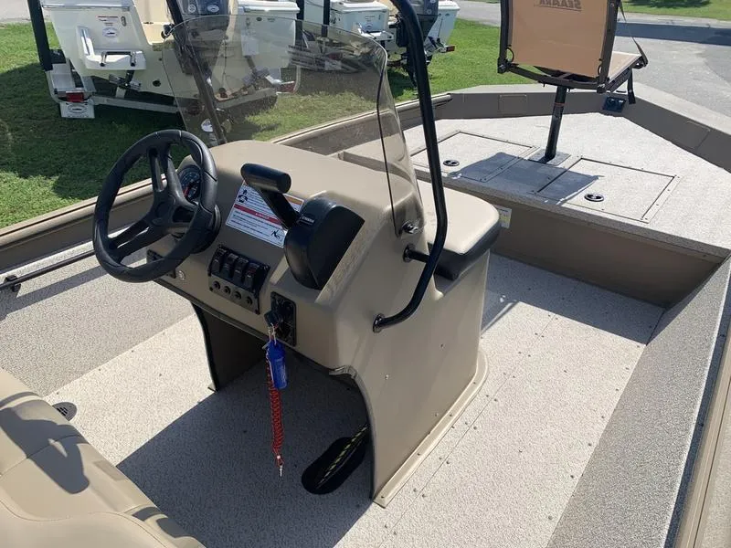 Slide: The Image of 2025 SeaArk Shadow 18 Center Console boat interior with steering wheel and seating. - 18