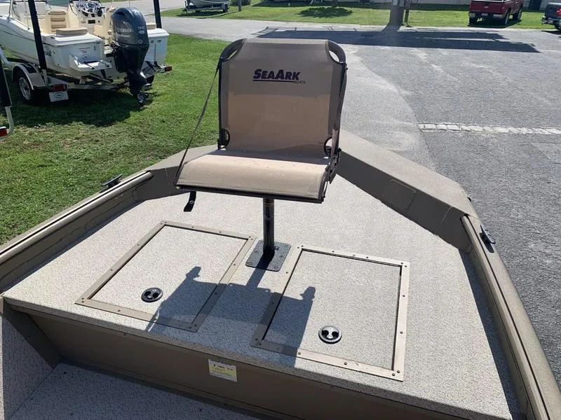 Slide: The Image of 2025 SeaArk Shadow 18 Center Console boat with elevated seat and storage compartments. - 21