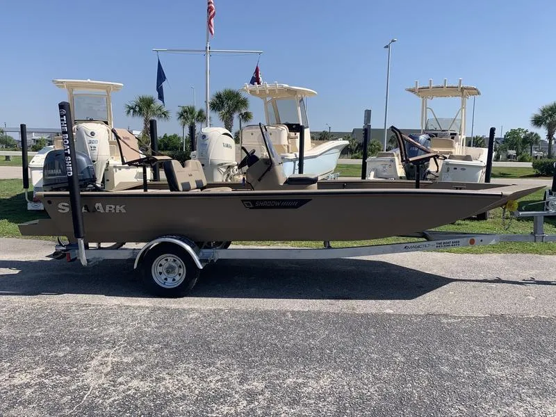 Slide: The Image of 2025 SeaArk Shadow 18 Center Console boat on trailer, parked outdoors. - 5