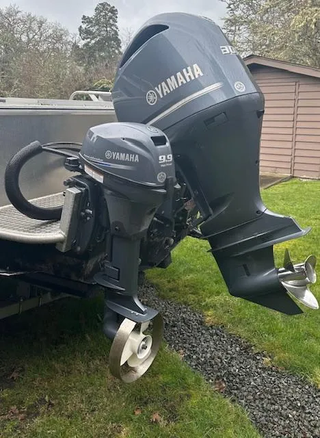 Slide: The Image of 2017 Hewescraft 240 Ocean Pro HT with Yamaha outboard motors on grassy area. - 12
