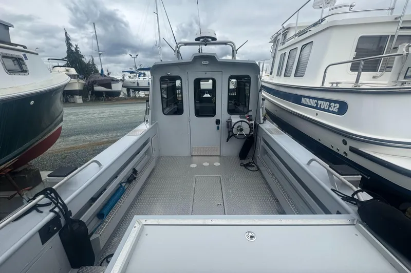 Slide: The Image of 2017 Hewescraft 240 Ocean Pro HT boat docked among other vessels. - 13