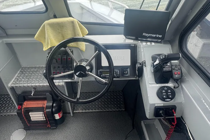 Slide: The Image of 2017 Hewescraft 240 Ocean Pro HT boat cockpit with steering wheel and navigation equipment. - 15