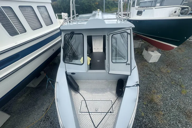 Slide: The Image of 2017 Hewescraft 240 Ocean Pro HT boat, docked, top view, open cabin doors. - 16