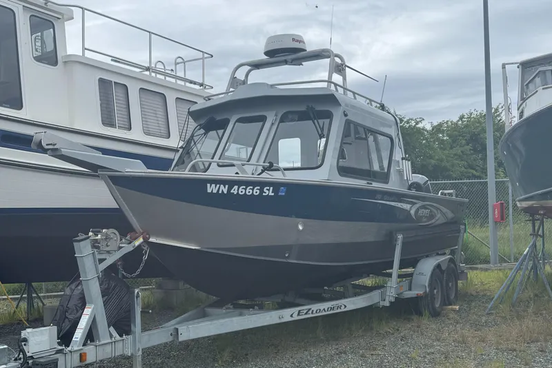 Slide: The Image of 2017 Hewescraft 240 Ocean Pro HT boat on trailer, parked outdoors. - 2
