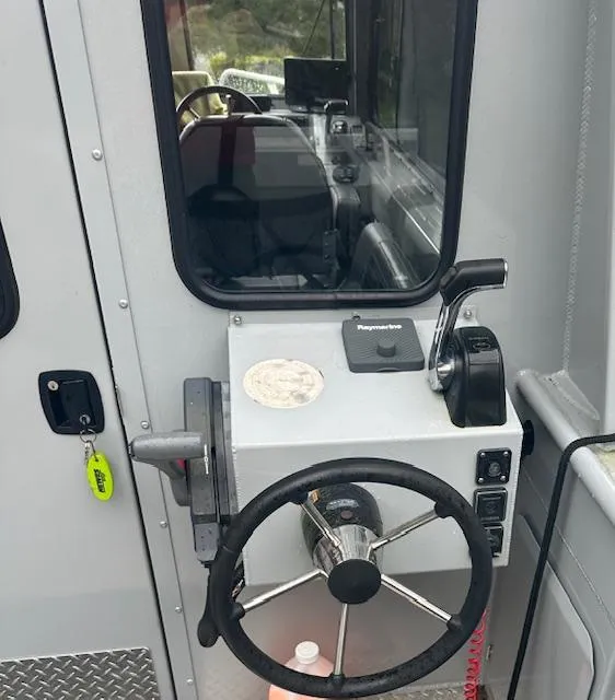 Slide: The Image of 2017 Hewescraft 240 Ocean Pro HT boat helm with steering wheel and controls. - 3