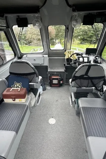 Slide: The Image of 2017 Hewescraft 240 Ocean Pro HT interior with seating, steering wheel, and windows. - 6