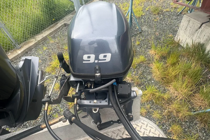 Slide: The Image of Outboard motor labeled "9.9" on a 2017 Hewescraft 240 Ocean Pro HT boat. - 9