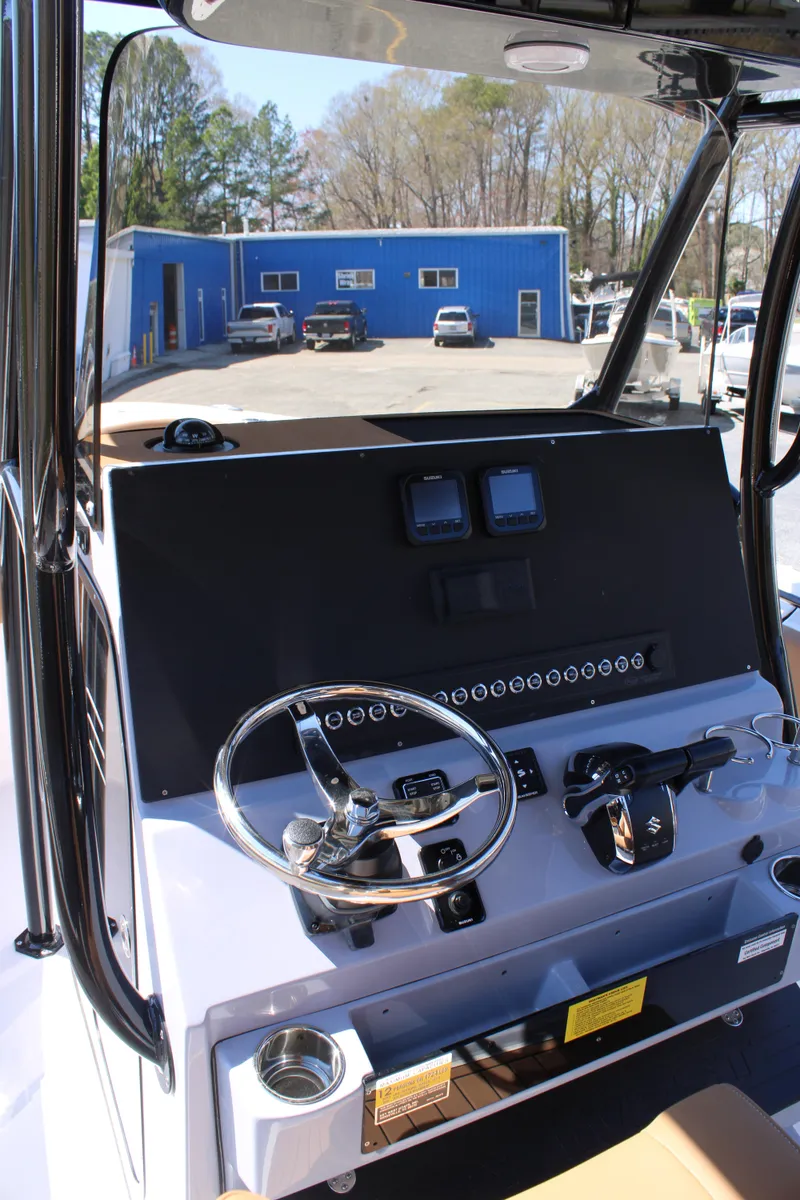 Slide: The Image of 2025 Key West 263 FS boat interior with compact marine toilet and storage. - 11