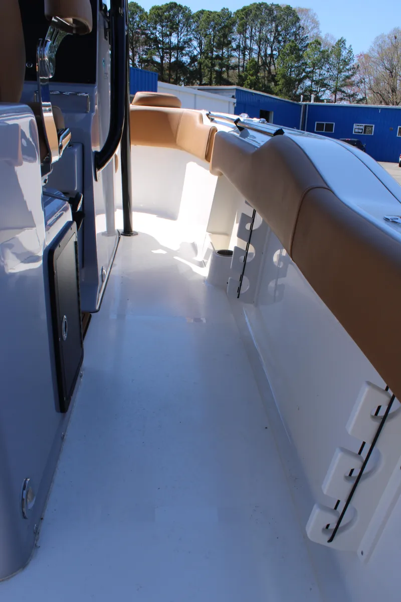 Slide: The Image of 2025 Key West 263 FS boat with tan seating and sleek design. - 14