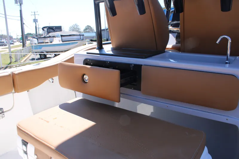 Slide: The Image of 2025 Key West 263 FS boat interior with tan seating and center console. - 15