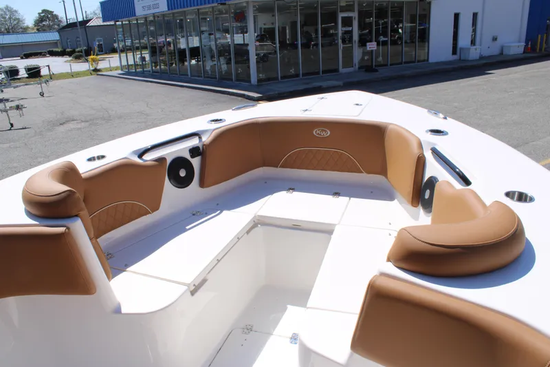 Slide: The Image of 2025 Key West 263 FS boat interior with brown seating and logo detail. - 19