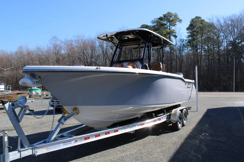 Slide: The Image of 2025 Key West 263 FS boat with dual Suzuki engines on a trailer. - 2