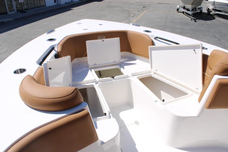 Slide: The Image of 2025 Key West 263 FS boat interior with tan seating, docked near a showroom. - 22