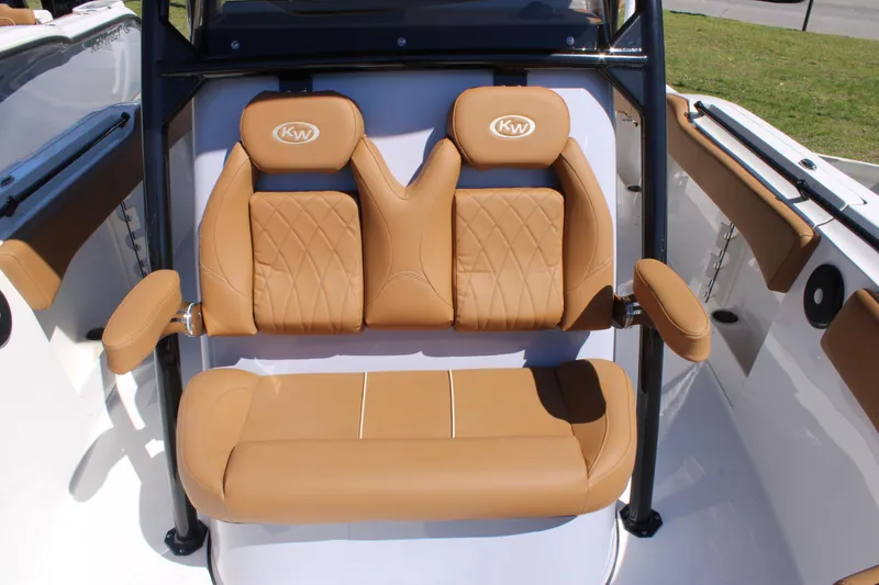Slide: The Image of 2025 Key West 263 FS boat interior with open storage compartment and tan seating. - 24