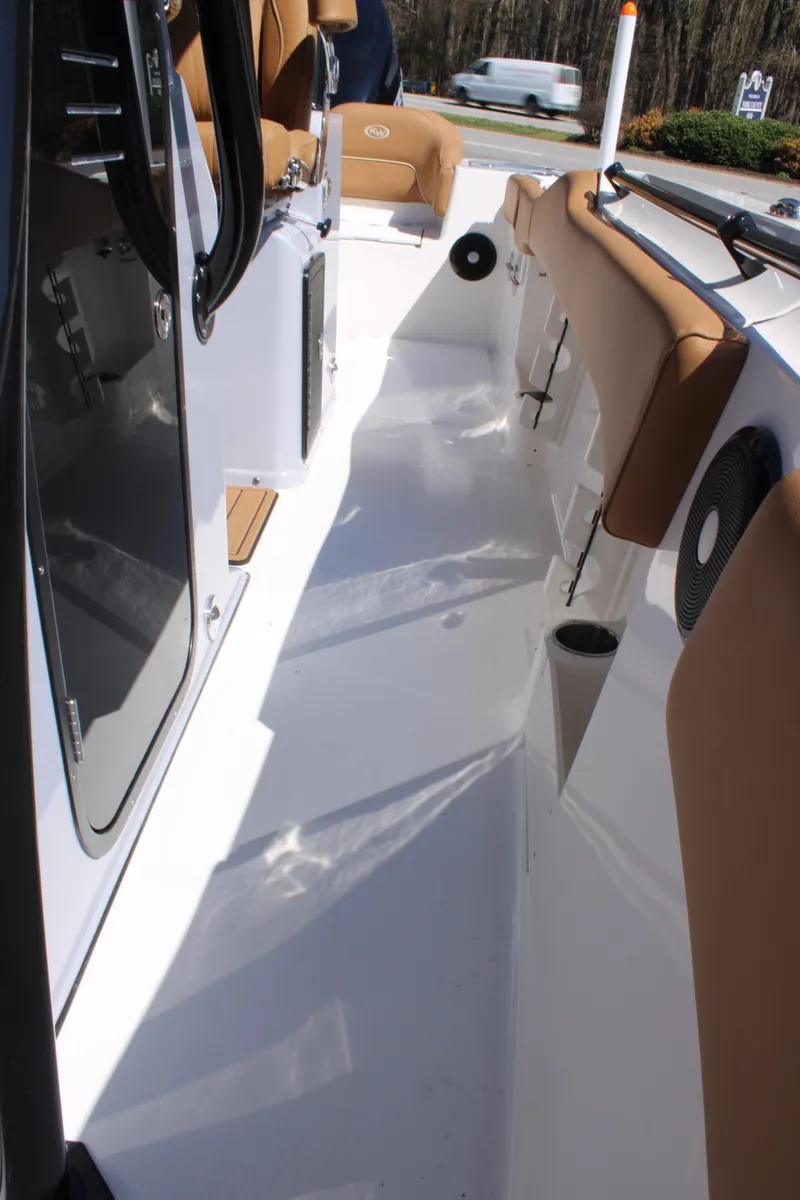 Slide: The Image of Luxurious tan seating on 2025 Key West 263 FS boat, featuring dual Suzuki engines. - 25